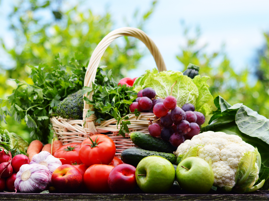 Basket with fresh vegetables and fruits. 